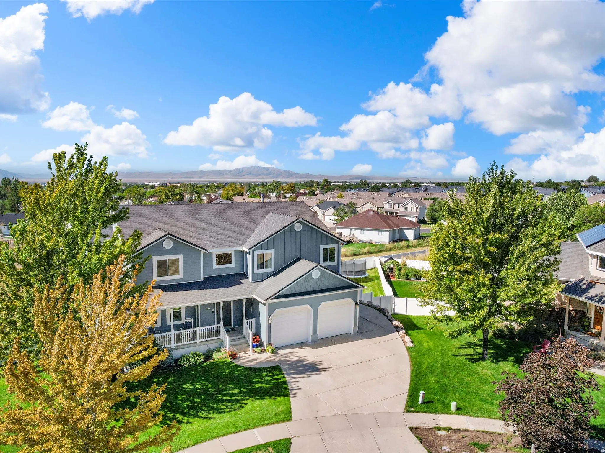 Two-story residence with a covered front porch, an attached two-car garage, and a concrete driveway