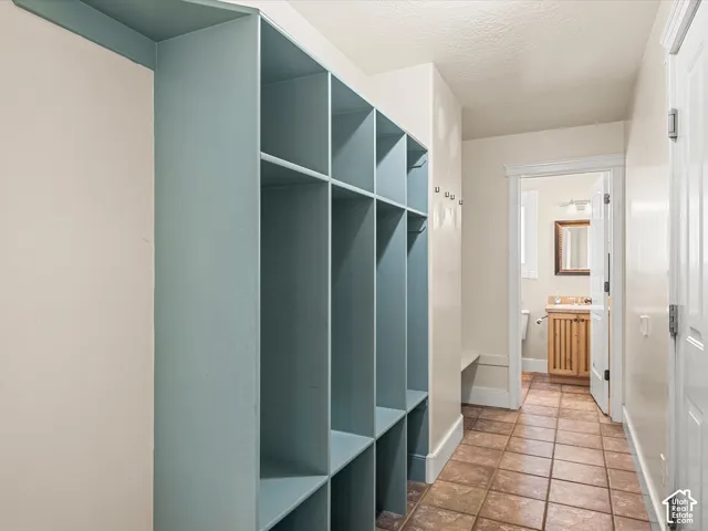 Built-in storage cubbies, wall-mounted coat hooks, and a built-in bench