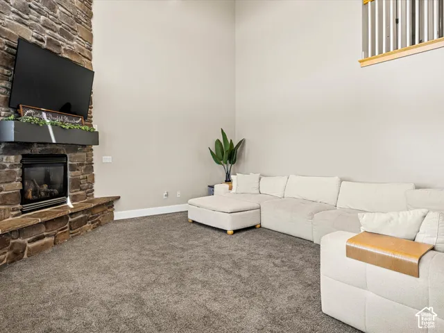 Stone-clad fireplace with a dark wood-finish mantel and integrated gas insert