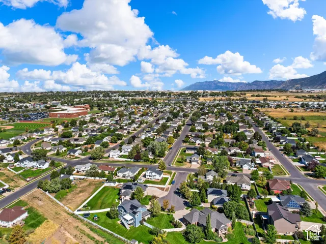Expansive residential area featuring numerous single-family homes with pitched roofs, mature trees, and paved streets
