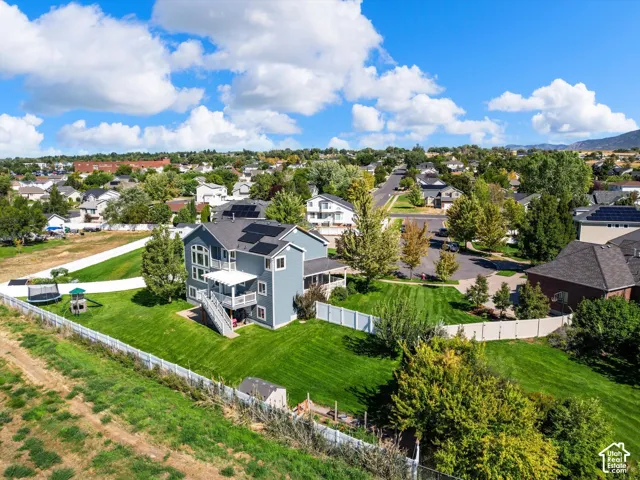 Expansive property with a large, manicured lawn and a multi-level deck