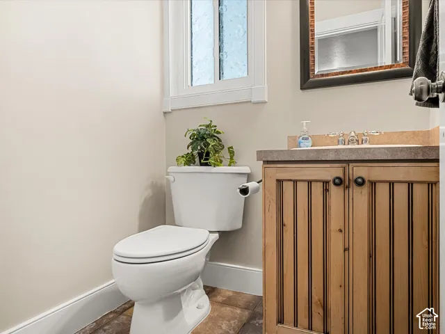 Wood-finish vanity with a stone countertop and an undermount sink