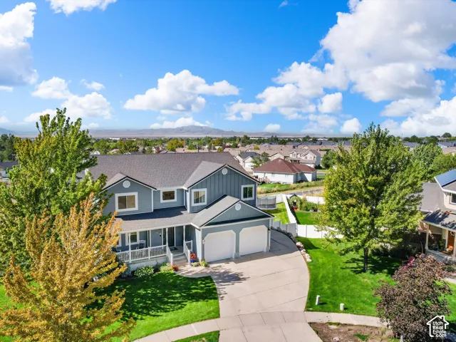 Two-story residence with a covered front porch, an attached two-car garage, and a concrete driveway