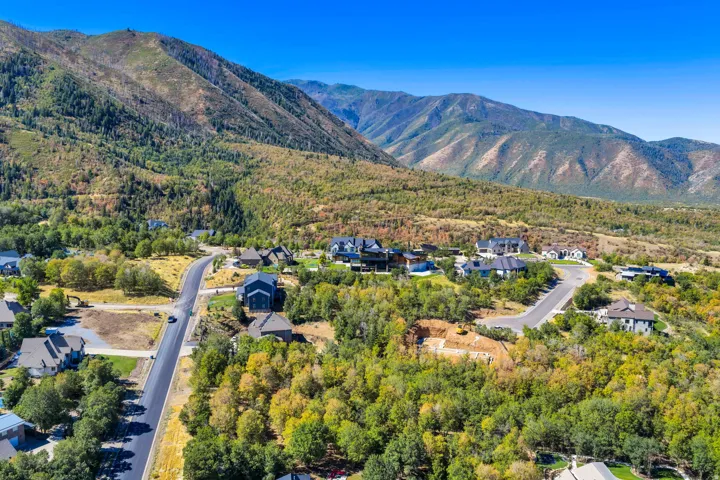 Mountainous terrain surrounds a residential area with paved roadways