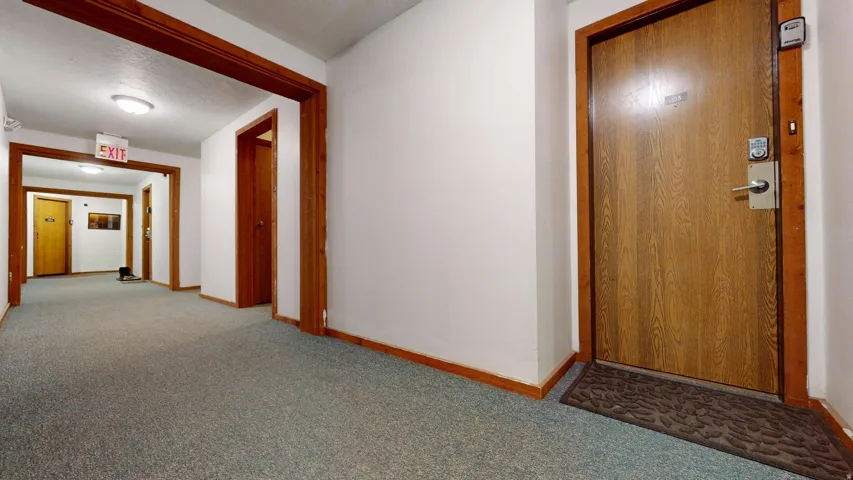 Wood-finish entry door with modern handle and digital lock