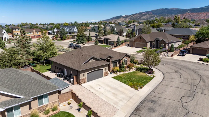 Single-story residence featuring a two-car garage, concrete driveway, and a shingle roof