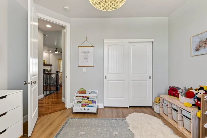 Wood-finish flooring throughout, with a white two-panel sliding closet door