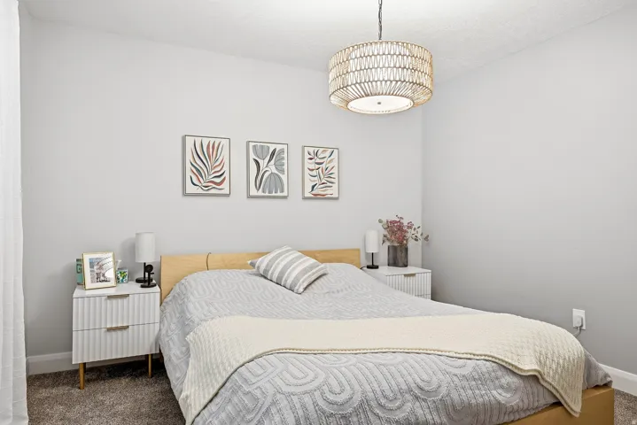 Recessed ceiling lighting, textured ceiling finish, neutral wall paint, and a woven pendant light fixture