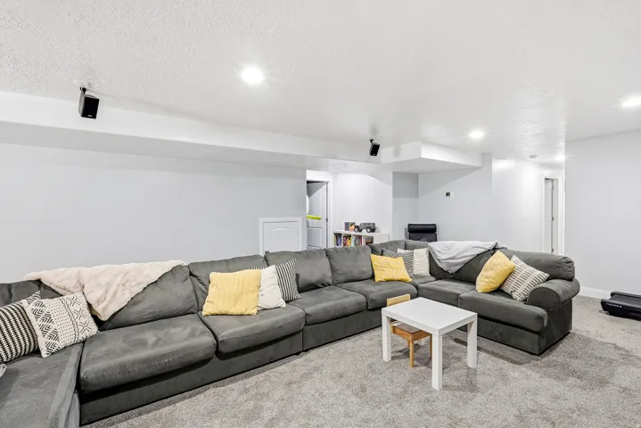 Recessed lighting illuminates the carpeted floor