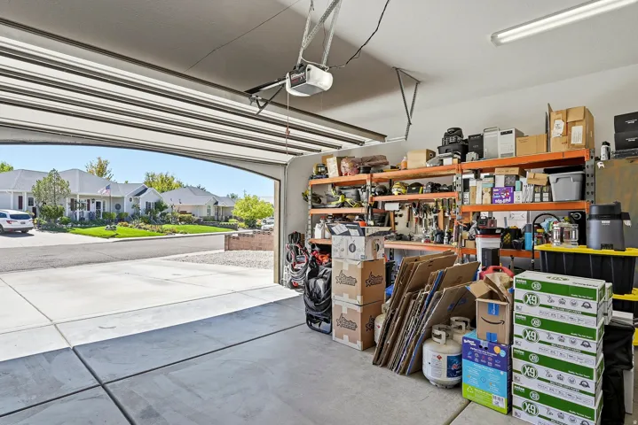 Attached garage with a concrete floor and a garage door opener
