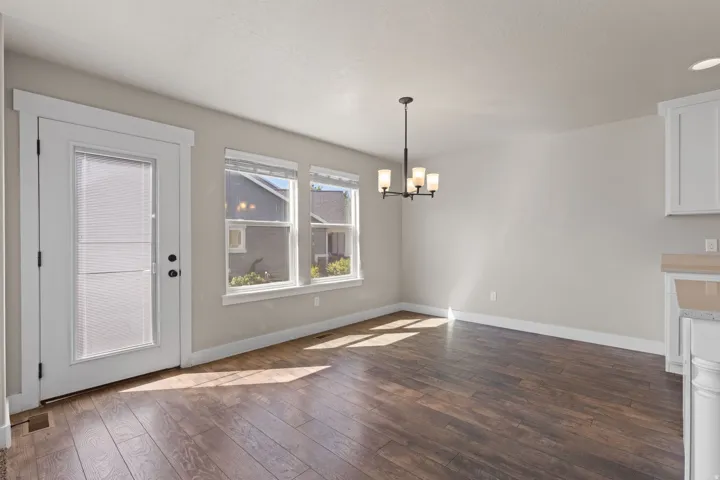 Wood-finish flooring throughout, complemented by a white trim package