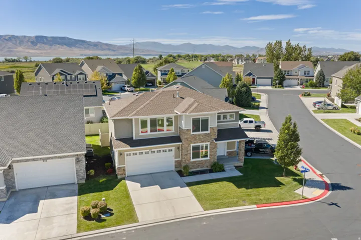 Contemporary two-story residence featuring a stone and siding exterior, an attached two-car garage, and a concrete driveway