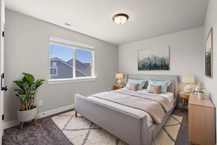 Recessed lighting, light-toned walls, and a large window with blinds
