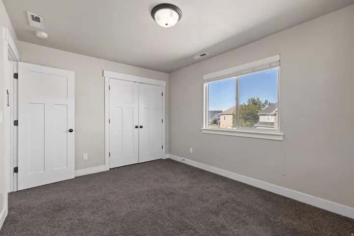 Recessed lighting and a flush-mount ceiling fixture illuminate the space