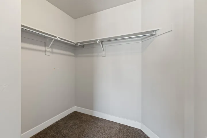 Wall-mounted shelving system with integrated hanging rods, providing organized storage