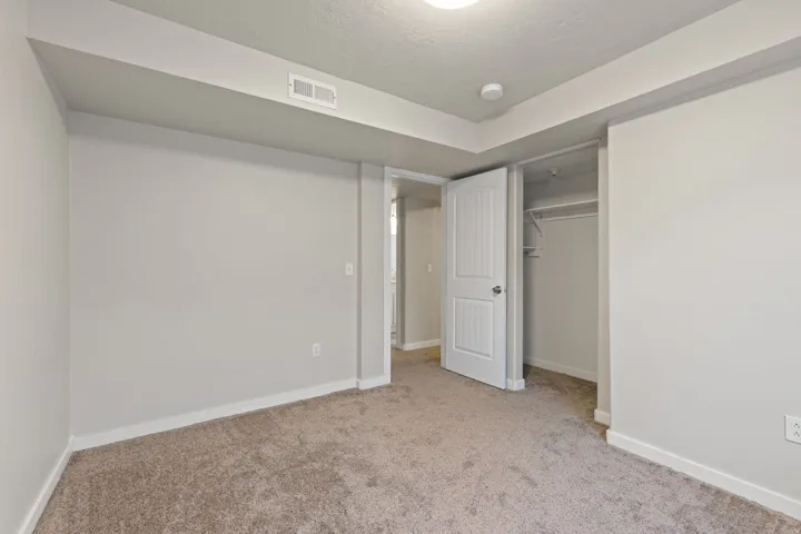 Neutral paint palette with wall-to-wall carpeting and white trim