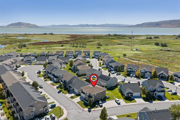 Residential community with a freshwater lake, surrounding wetlands, and distant mountains