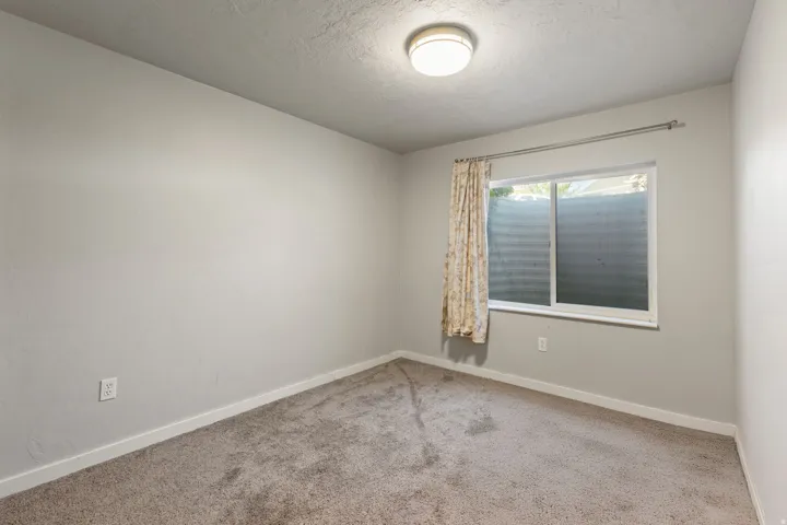 Carpeted flooring, neutral wall tones, and a flush mount ceiling light fixture