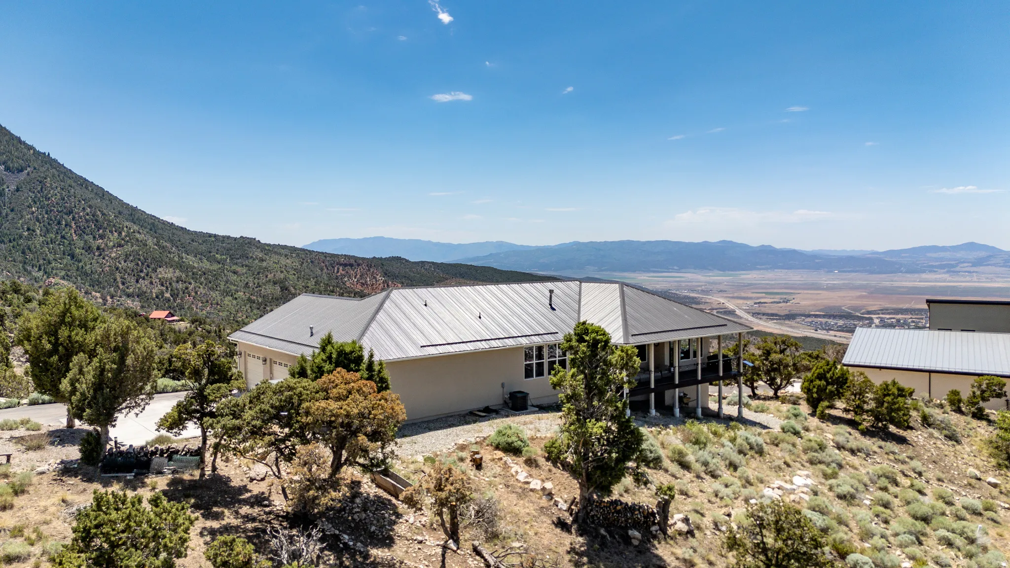 Expansive property with a light-toned exterior, multi-level deck, and a detached structure