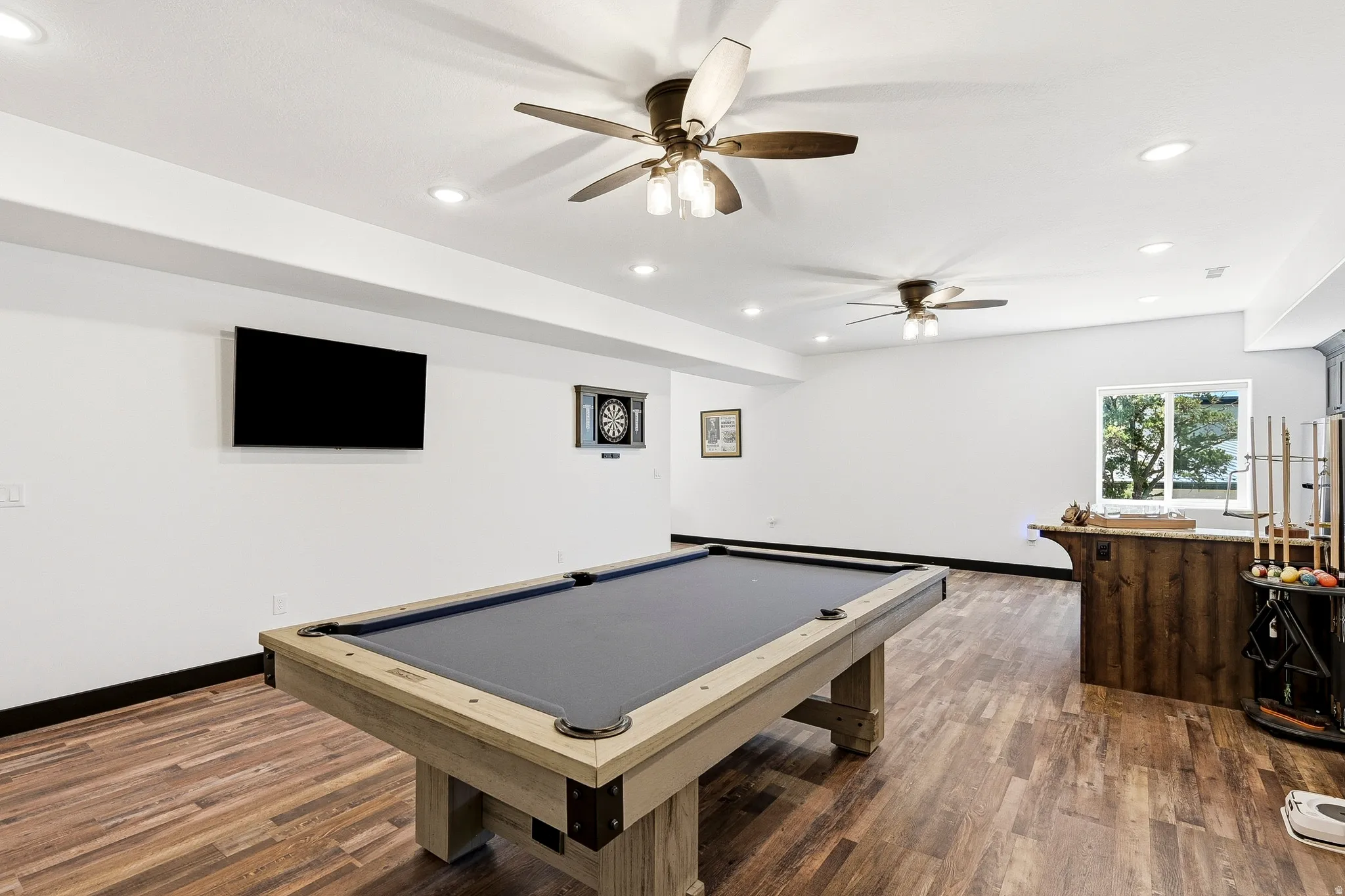 Wood-finish flooring, recessed lighting, and ceiling fans