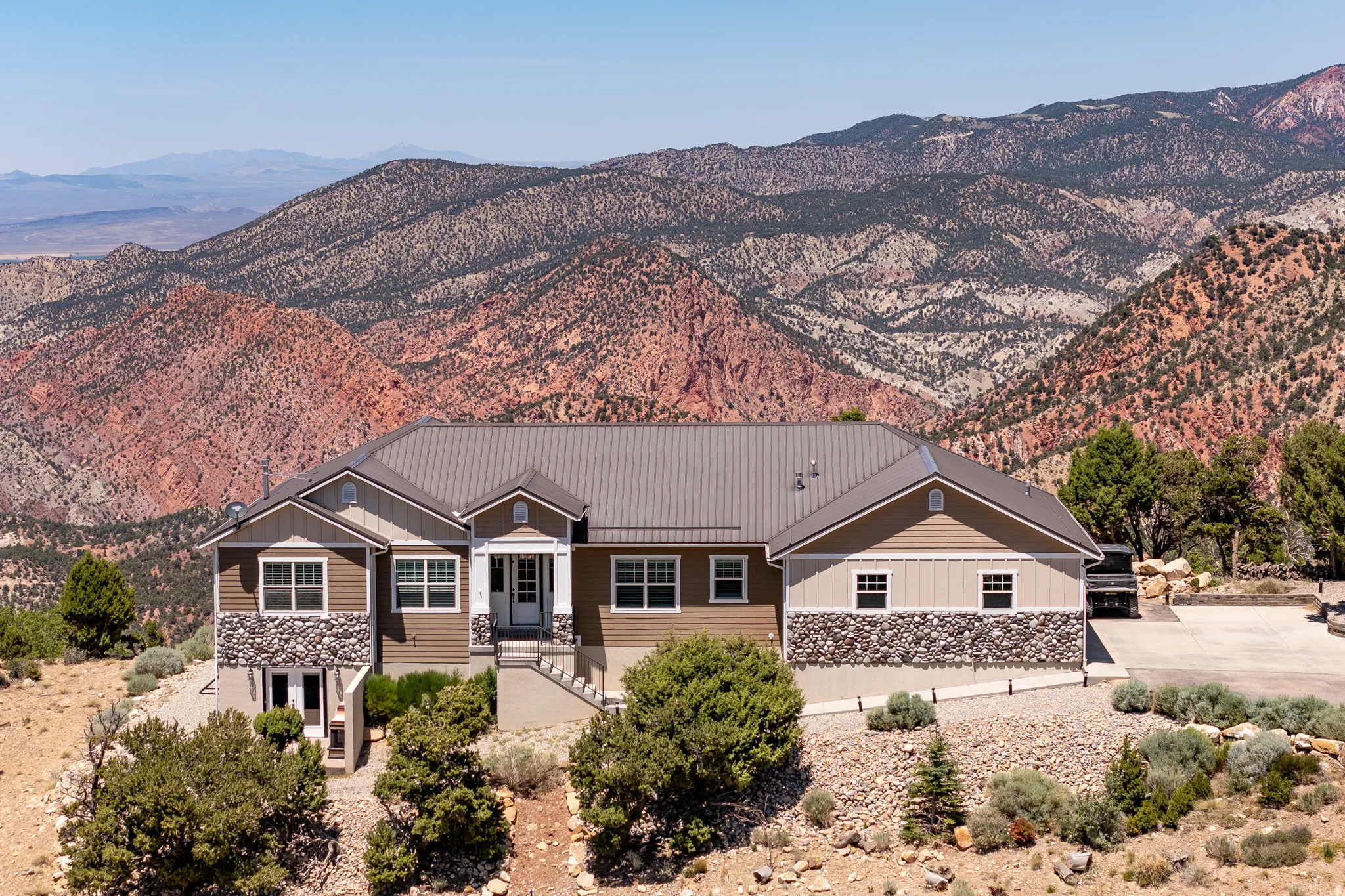 Exterior featuring a metal roof, stone accents, and composite siding