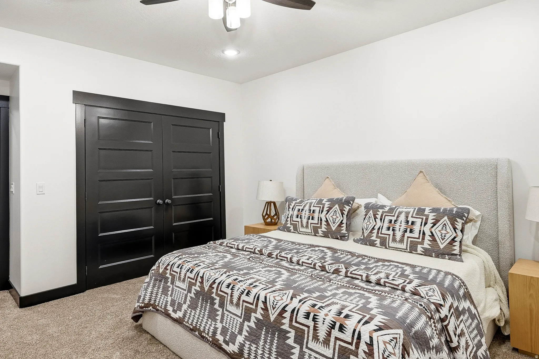 Recessed lighting, ceiling fan, carpet flooring, and dark-paneled closet doors
