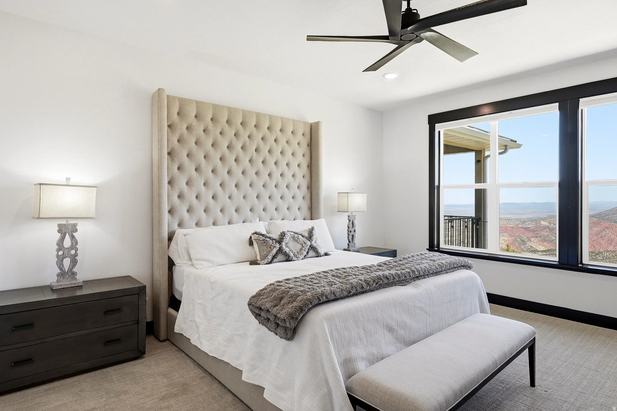 Large windows with dark trim, recessed lighting, and a ceiling fan