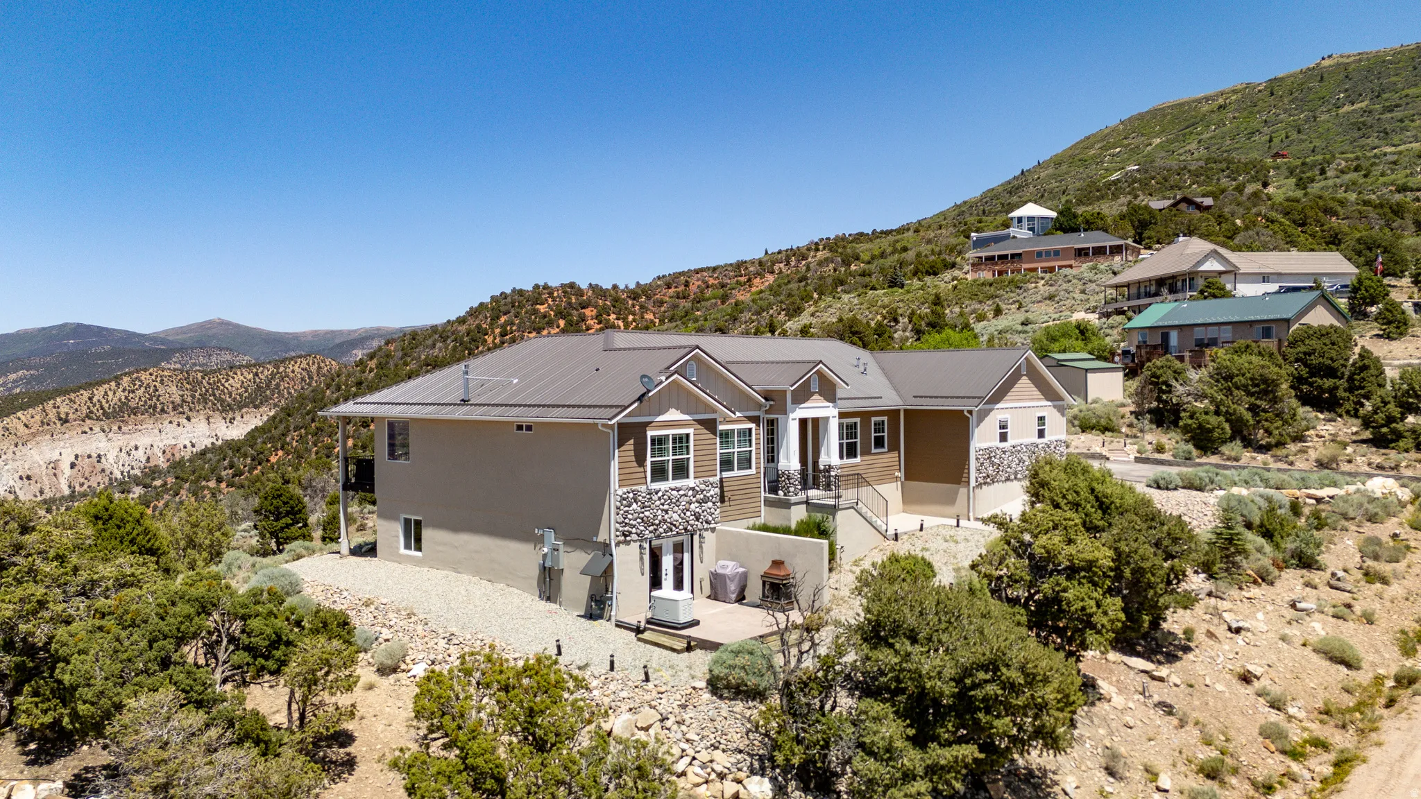 Multi-level exterior with a metal roof and stone accents