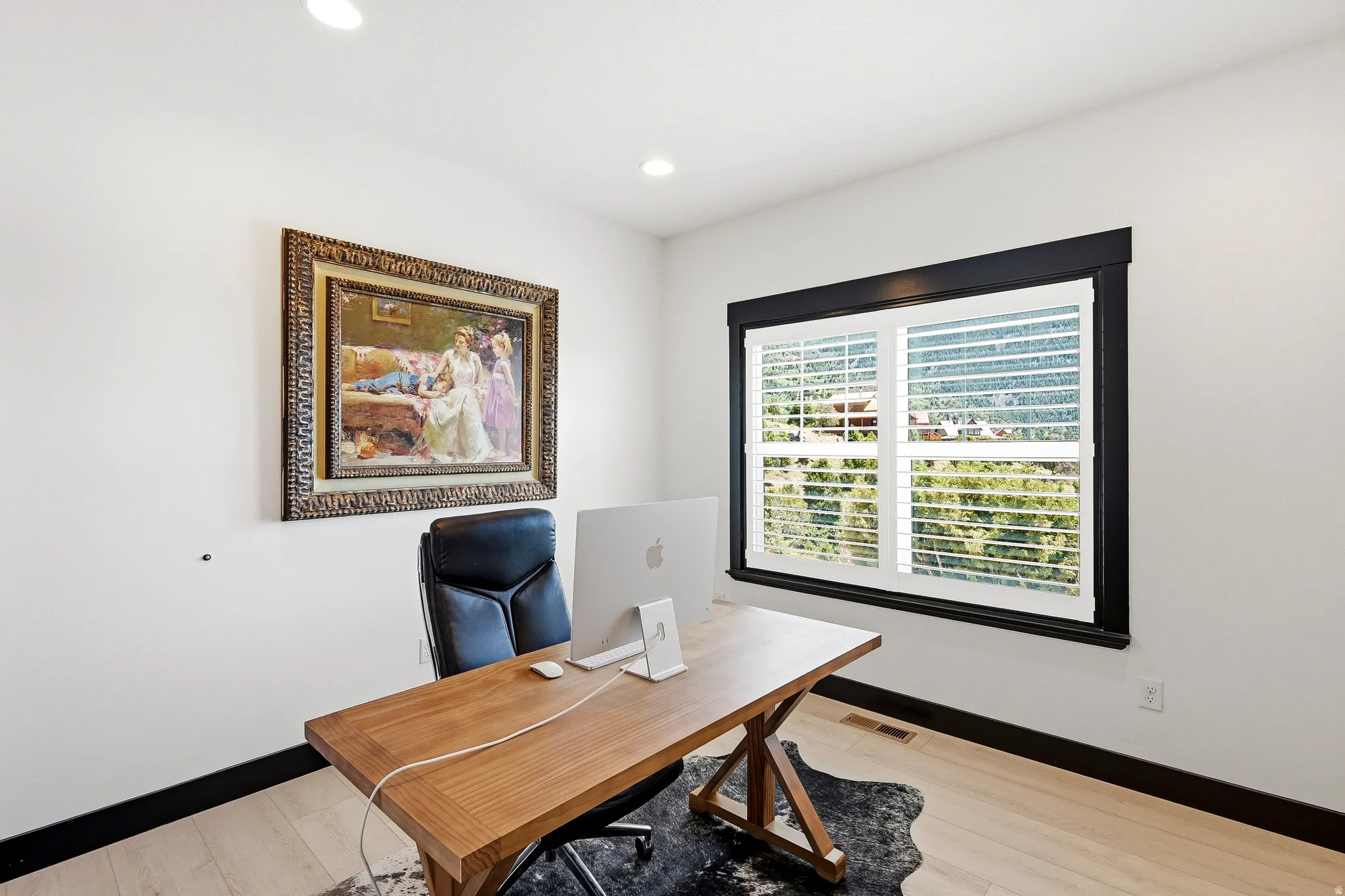 Hardwood-finish flooring, recessed lighting, and a window with plantation shutters