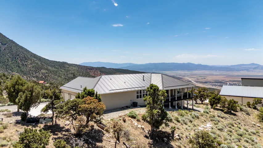 Expansive property with a light-toned exterior, multi-level deck, and a detached structure