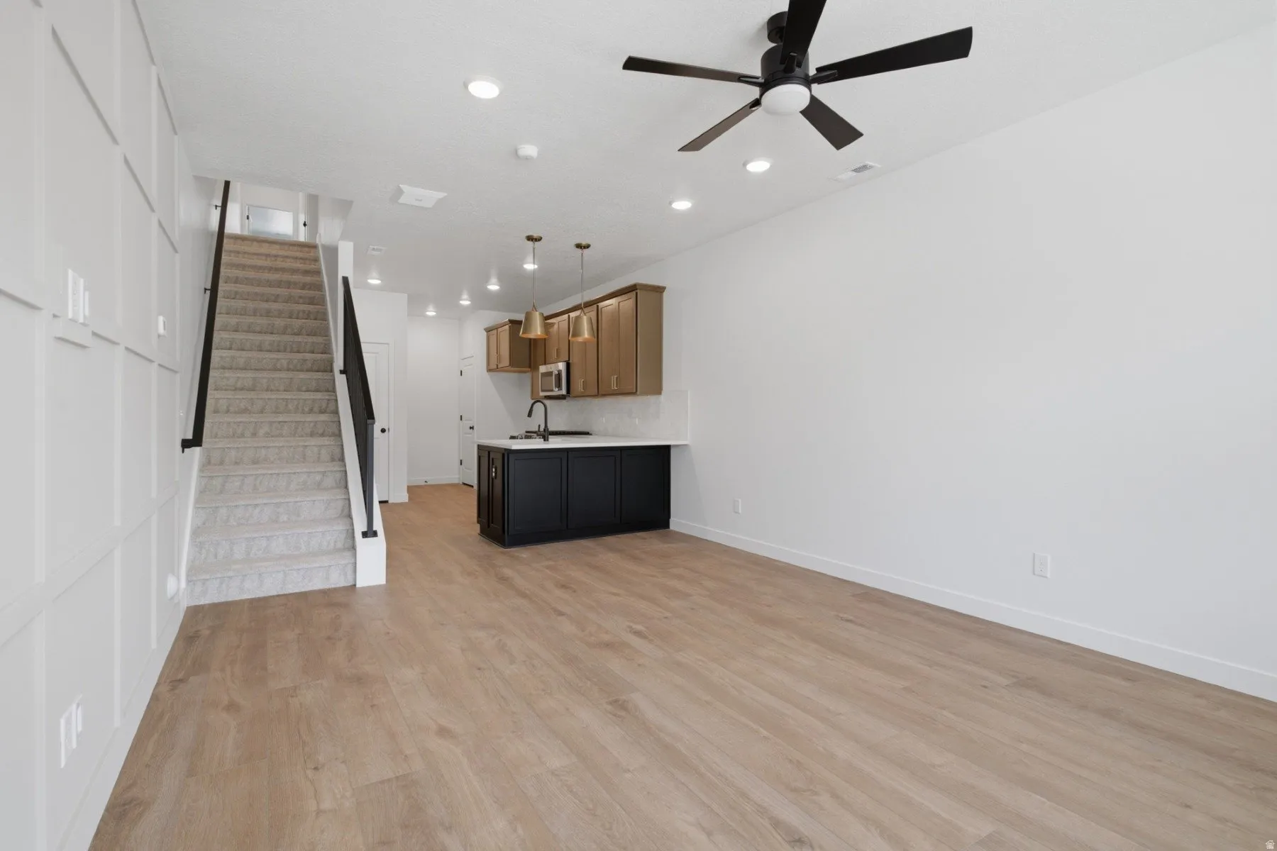 Wood-finish flooring, recessed lighting, and a modern ceiling fan