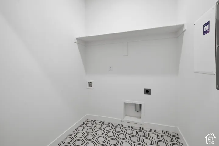 Geometric-patterned floor tiling, built-in shelving, and white walls