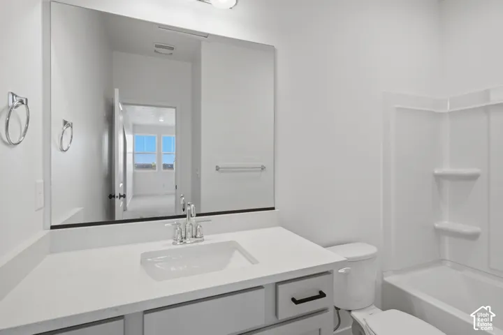 White vanity with an integrated sink and chrome fixtures