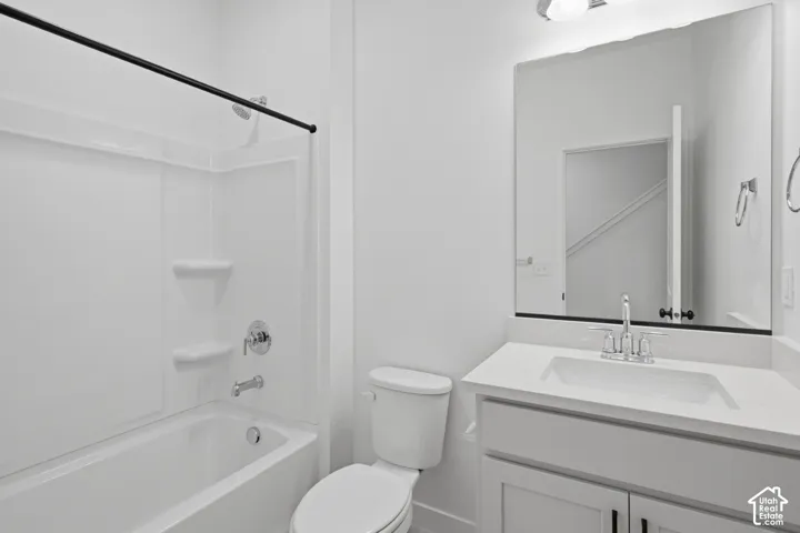 White shaker style vanity with a single basin sink and a solid surface countertop