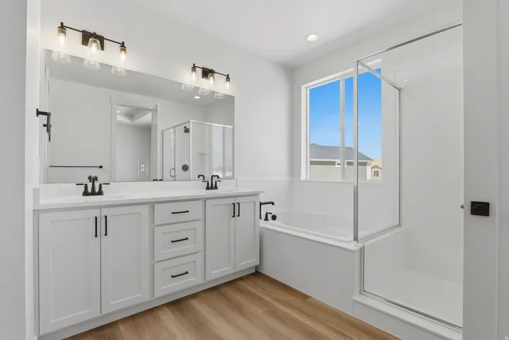 Dual vanity with white cabinetry, quartz countertop, and matte black fixtures