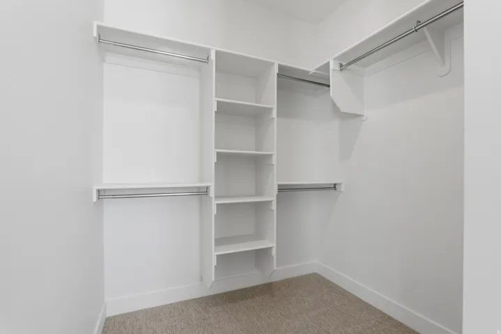 White built-in shelving and hanging rods