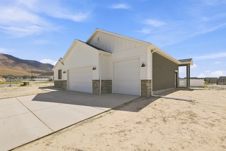 Contemporary exterior featuring white vertical siding and stucco accents