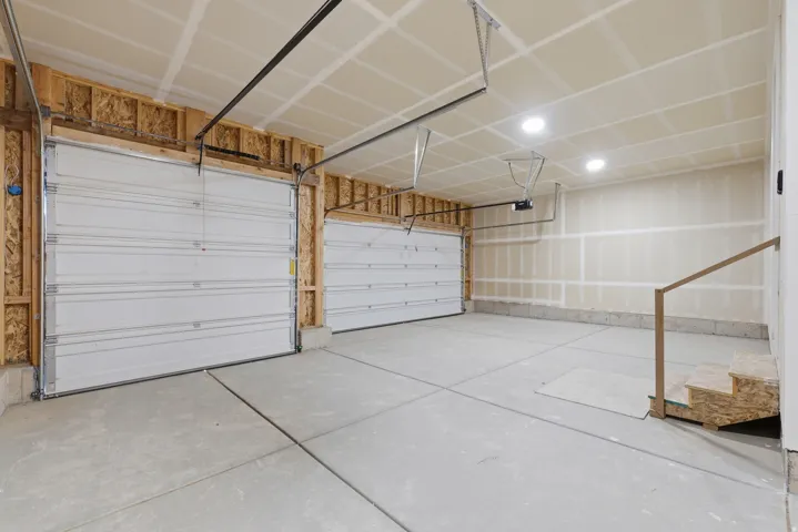 Two white sectional garage doors
