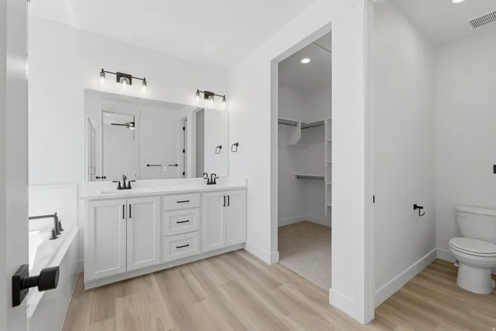 Dual vanity with white cabinetry and matte black hardware