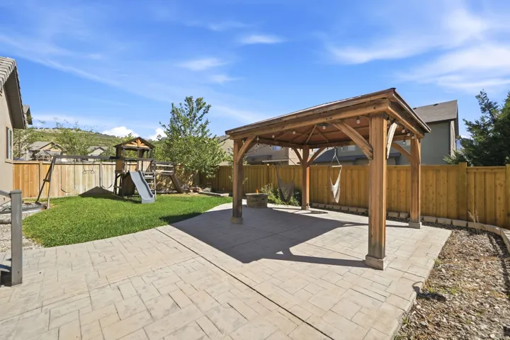 Expansive stamped concrete patio with a built-in wooden gazebo