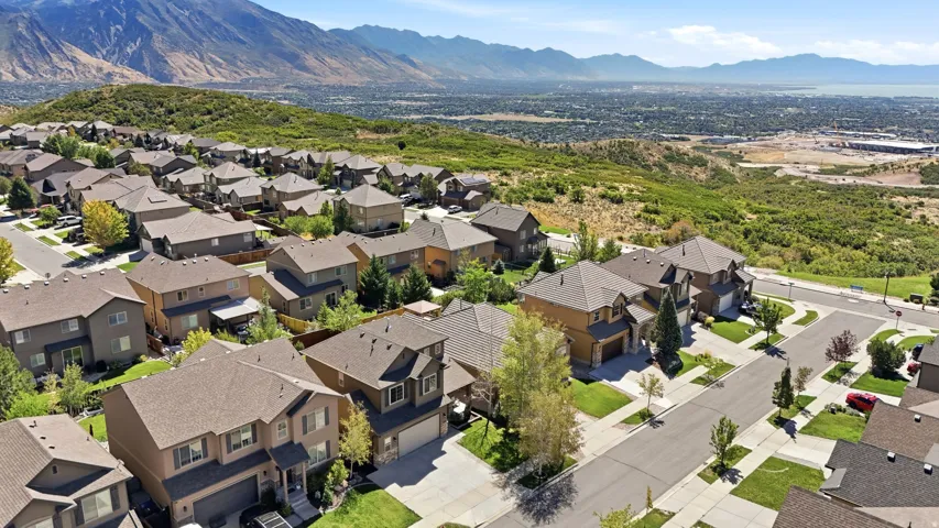 Mountain landscape, suburban neighborhood, paved streets, detached single-family homes, and green landscaping