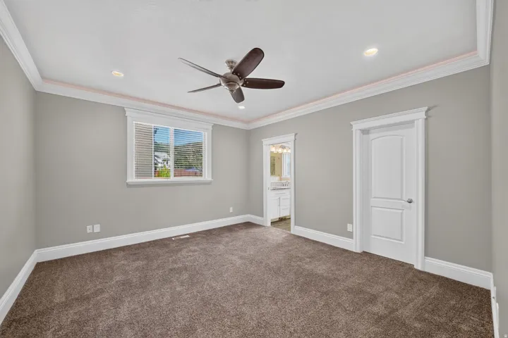 Recessed lighting and a ceiling fan enhance the room's comfort