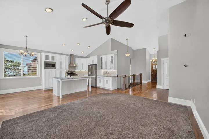 White cabinetry with brushed nickel hardware, stainless steel appliances, recessed lighting, wood-finish flooring, and a ceiling fan