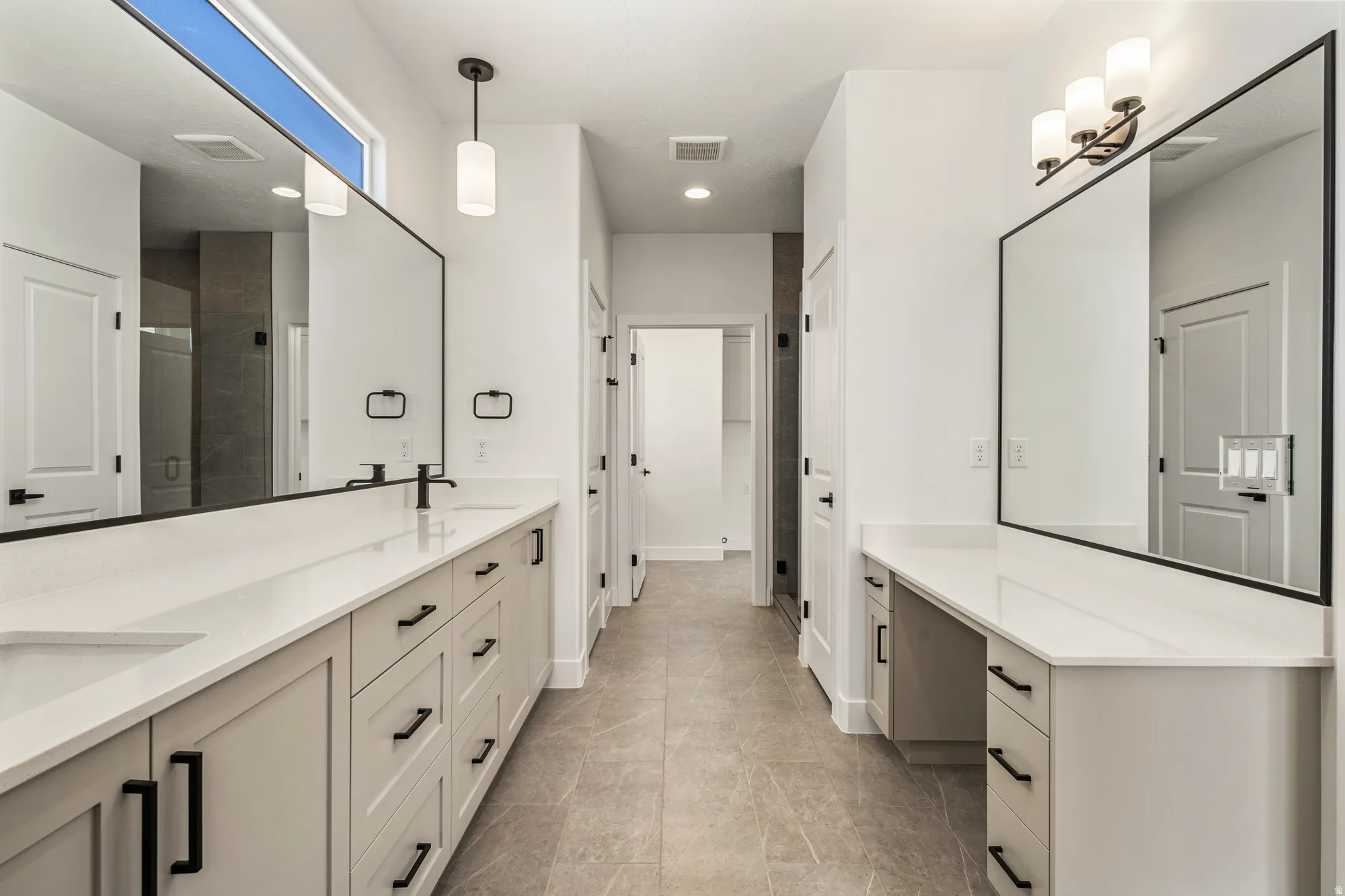 Dual vanities with white countertops and integrated sinks