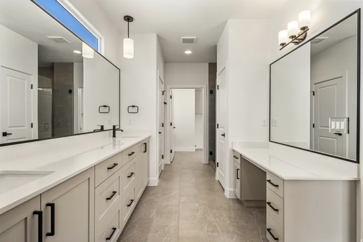 Dual vanities with white countertops and integrated sinks