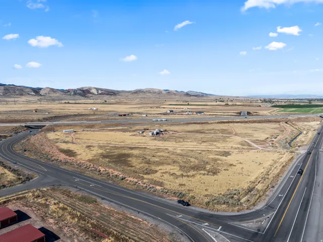 Expansive land parcel featuring direct road frontage and distant mountain scenery