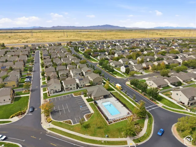 Expansive residential community with uniform housing, a central recreational pool, and ample parking facilities