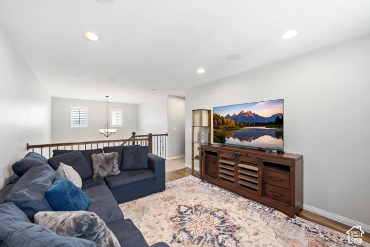 Open loft area featuring recessed lighting and wood-finish flooring