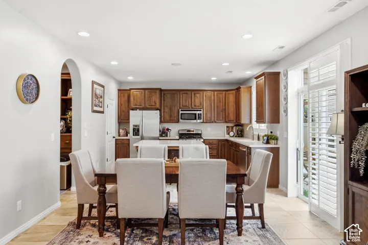 Spacious kitchen featuring wood-finish cabinetry, stainless steel appliances, and light-toned countertops