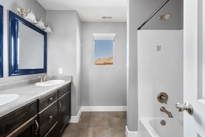 Dual vanity with undermount sinks and dark wood-finish cabinetry